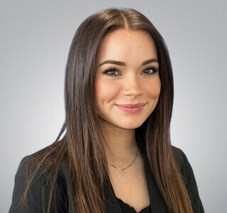 woman with long brown hair and smiling for the camera