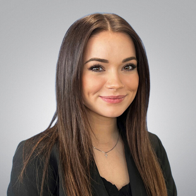 woman with long brown hair and smiling for the camera